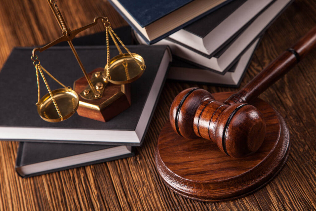 law-themed stock photo involving law books, a scale, and wooden gavel and sound block