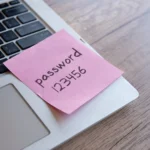 Password on a sticky note on laptop
