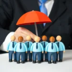 Representation of Cyber Insurance Showing Employees Under a Red Umbrella